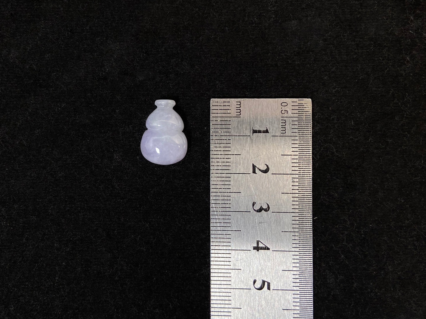 This lavender jade is carved into a semi calabash shape.