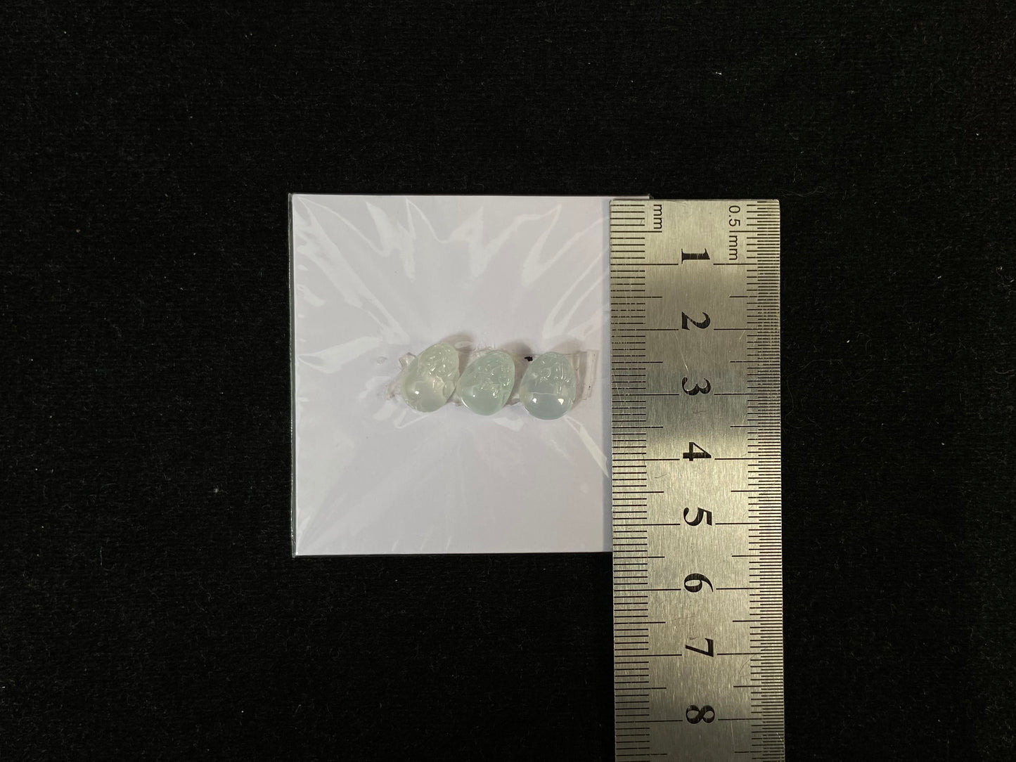 Three front-facing Pixiu carvings in icy jadeite.