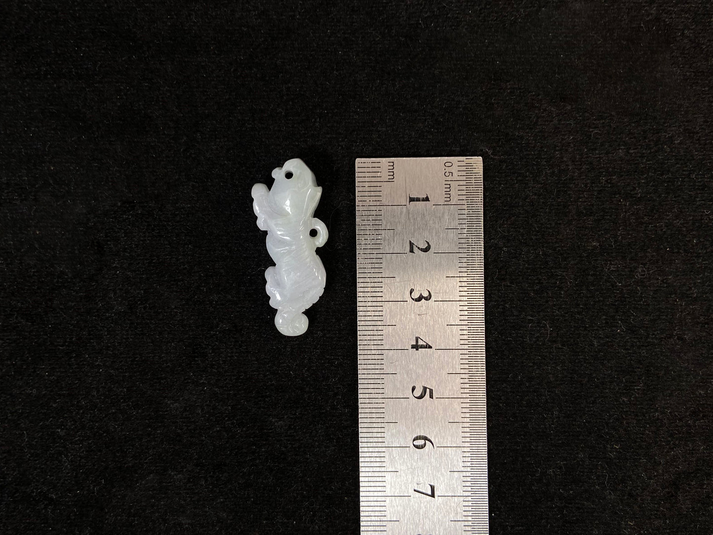 A pale green jade tiger with subtle lavender undertones.