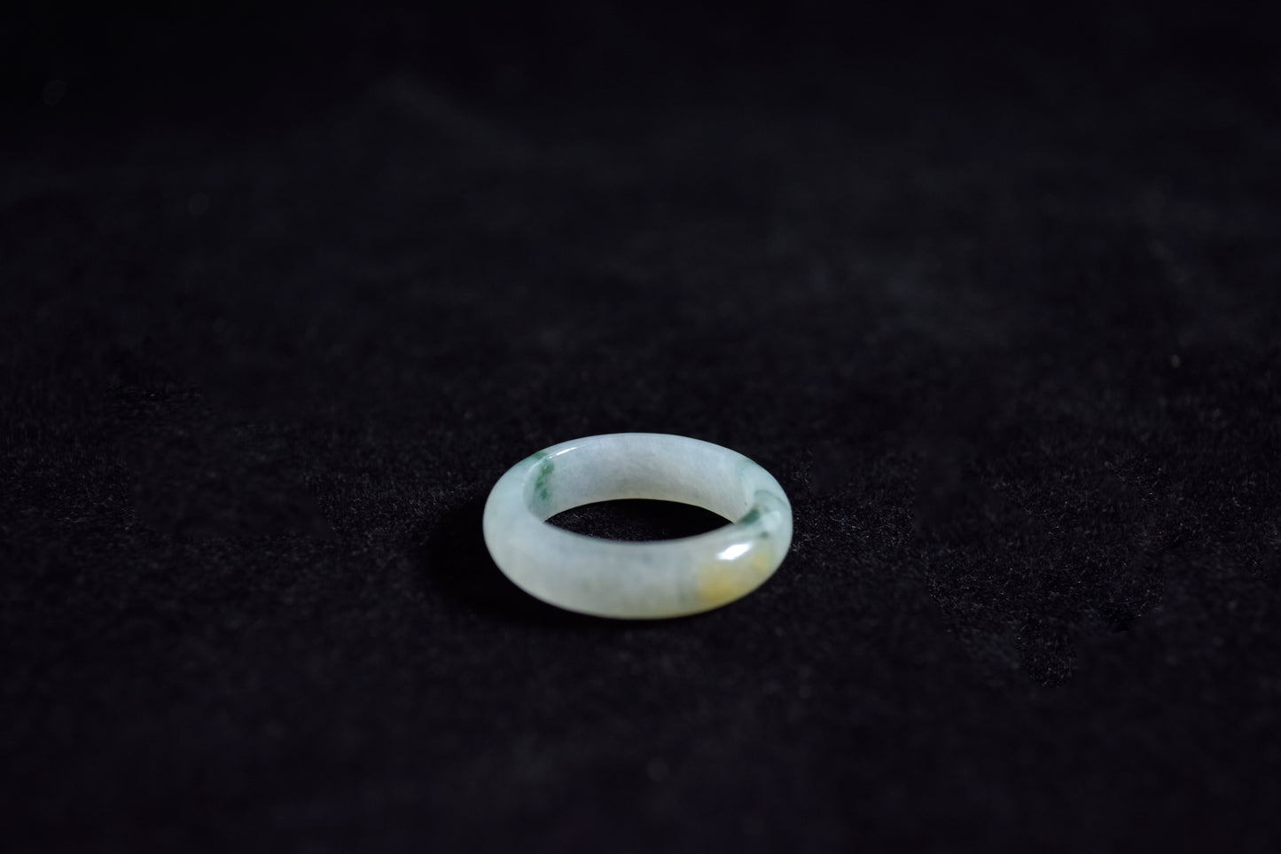 Clear gemstone ring on a dark textured surface