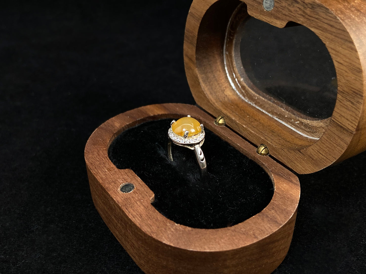 A round brown yellow jade set in 925 silver with prong setting.