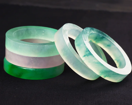 Five unpolished jadeite bangles.