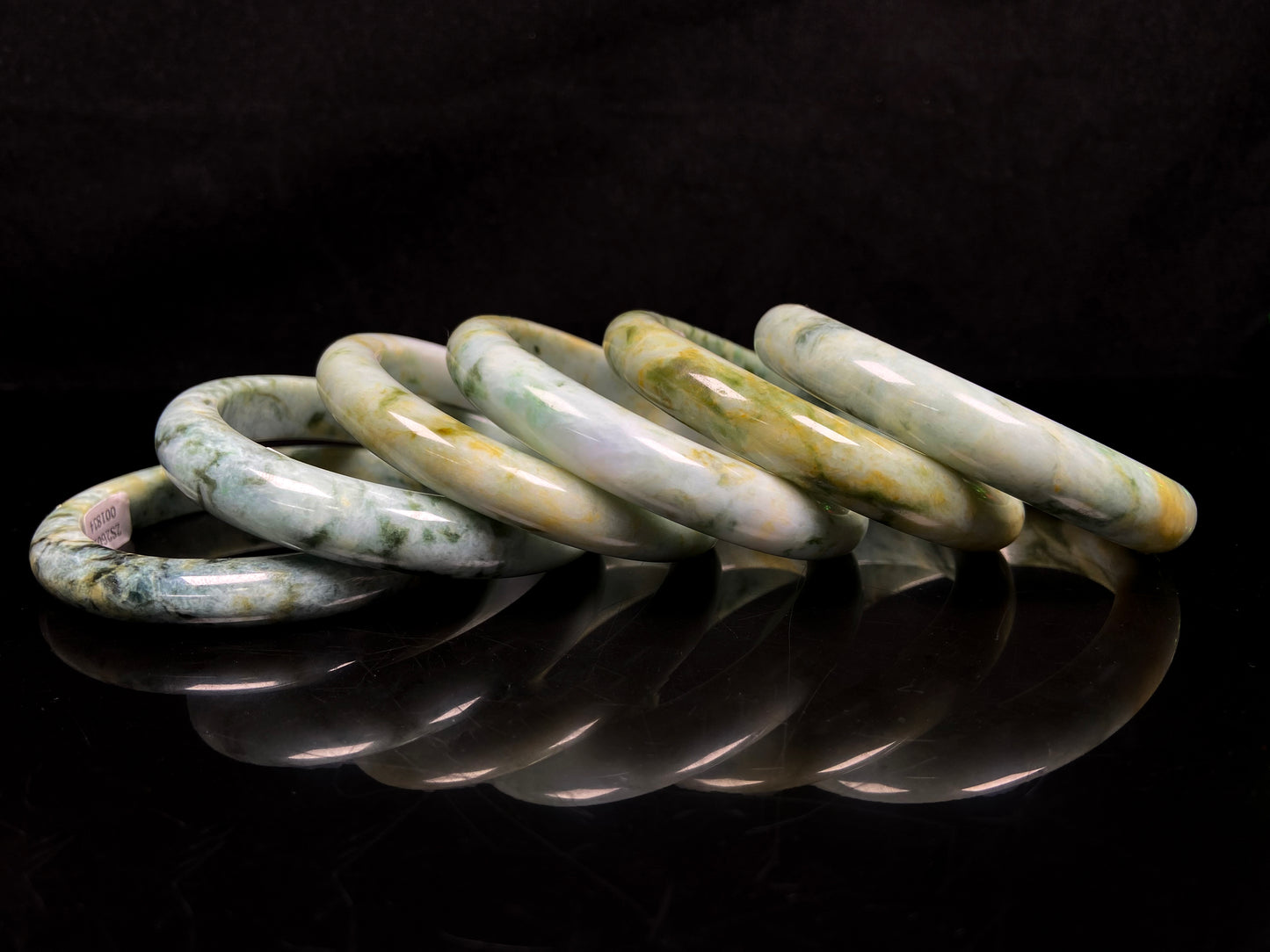 Mossy green with honeyed veins jadeite bangle.