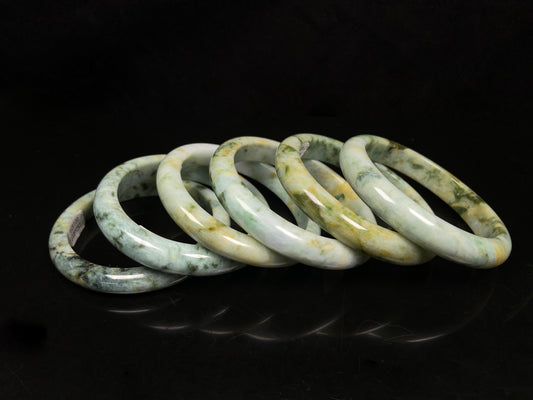 Mossy green with honeyed veins jadeite bangle.