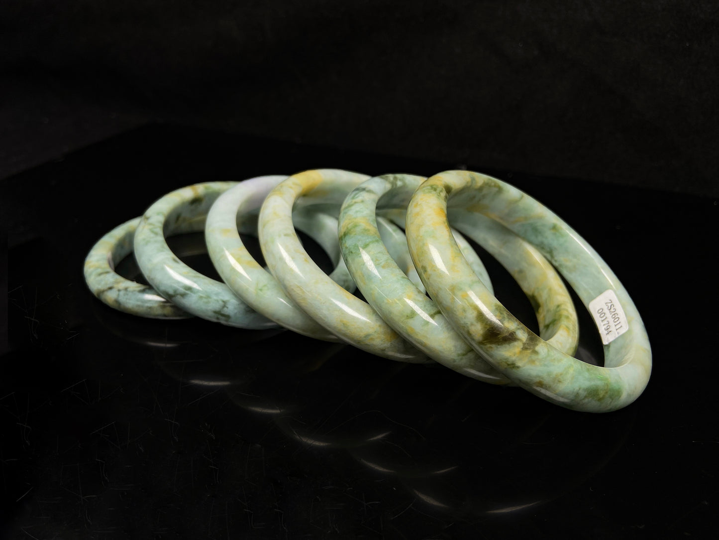 Mossy green with honeyed veins jadeite bangle.