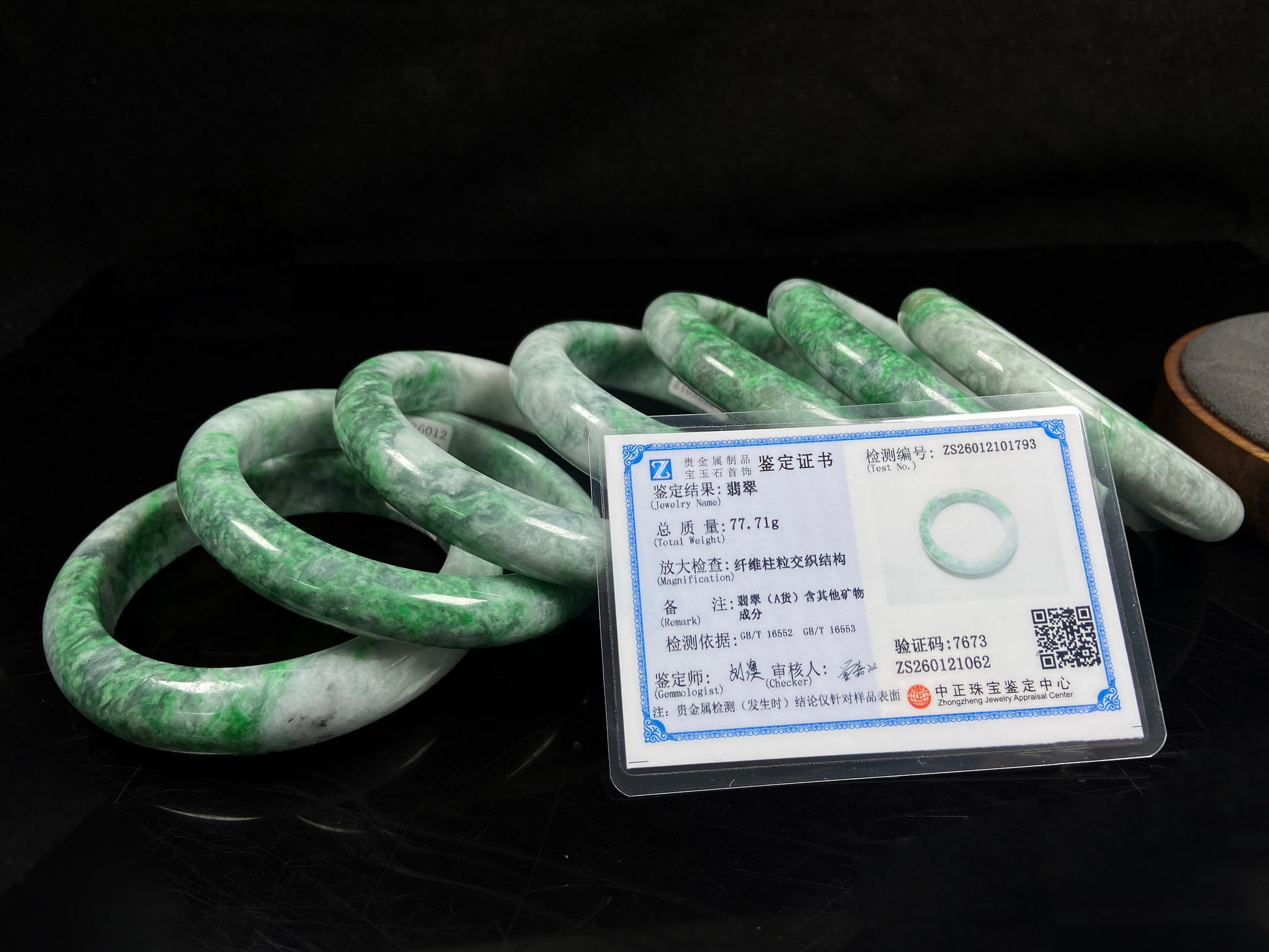 A group of white-base green-pattern jadeite bangles.
