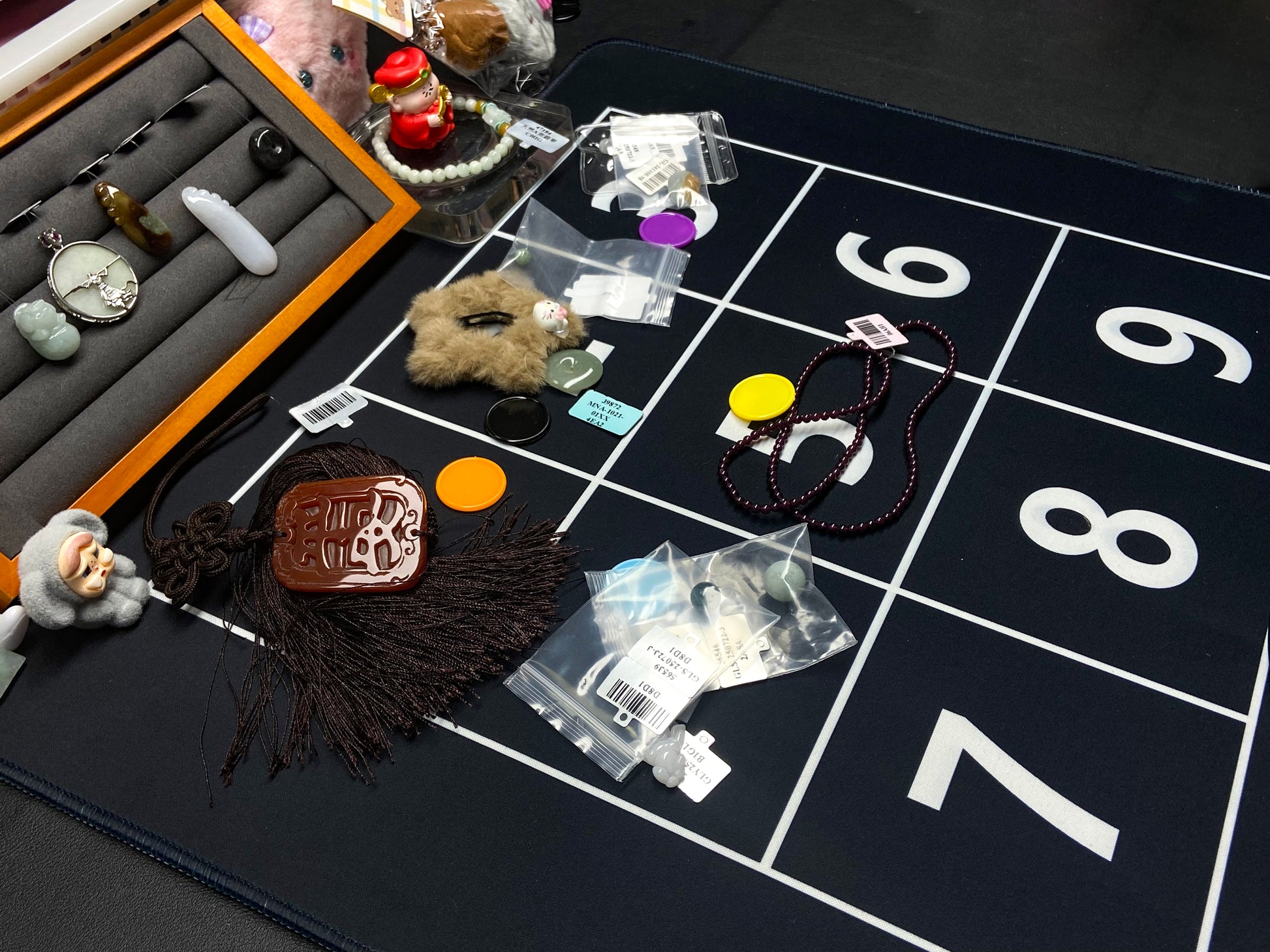 Collection of small items on a grid with numbers, possibly for sorting or categorizing.