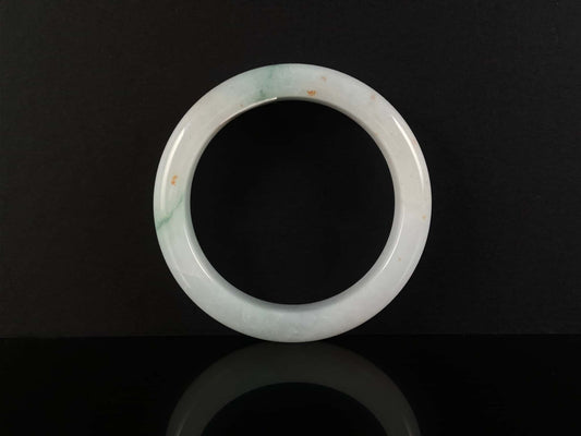 A soft white with red and green jadeite bangle.