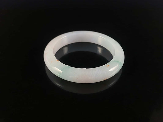 A soft white with red and green jadeite bangle.