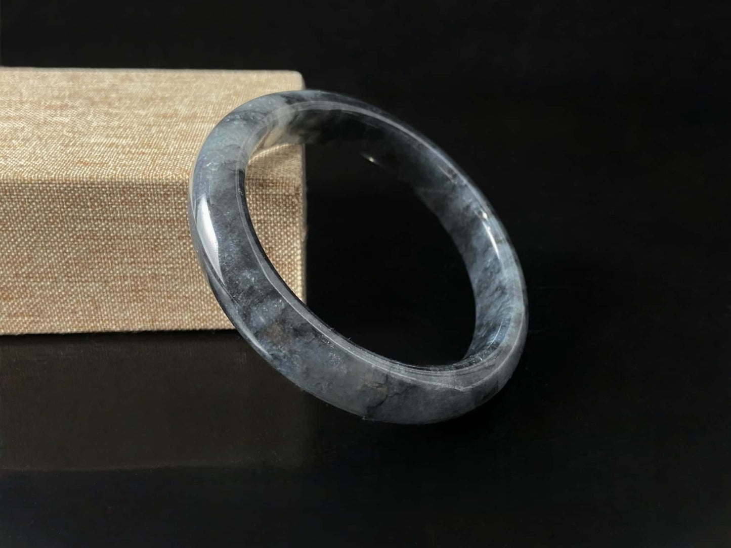 A grey cloud veil jadeite bangle.