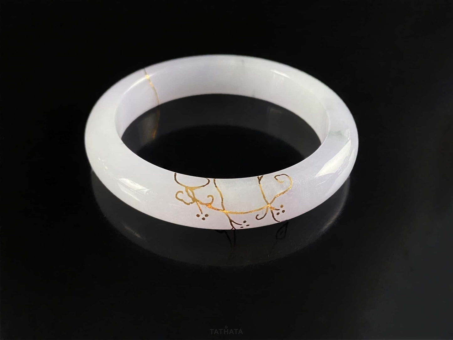 A pale violet golden stitch jadeite bangle.