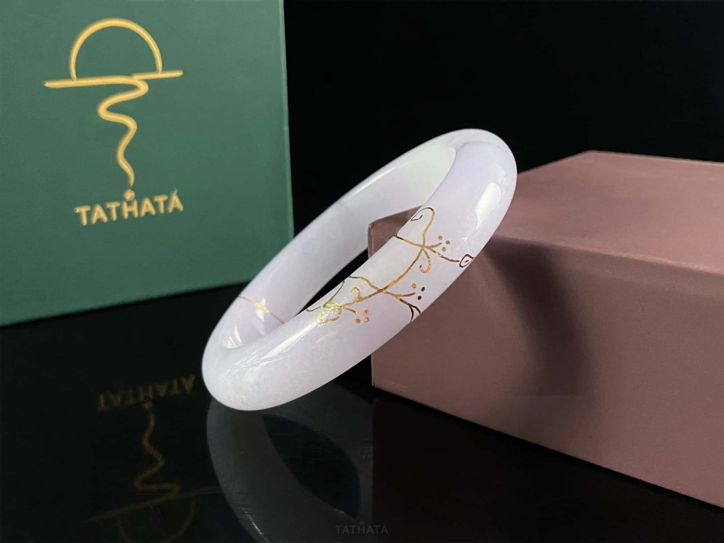 A pale violet golden stitch jadeite bangle.