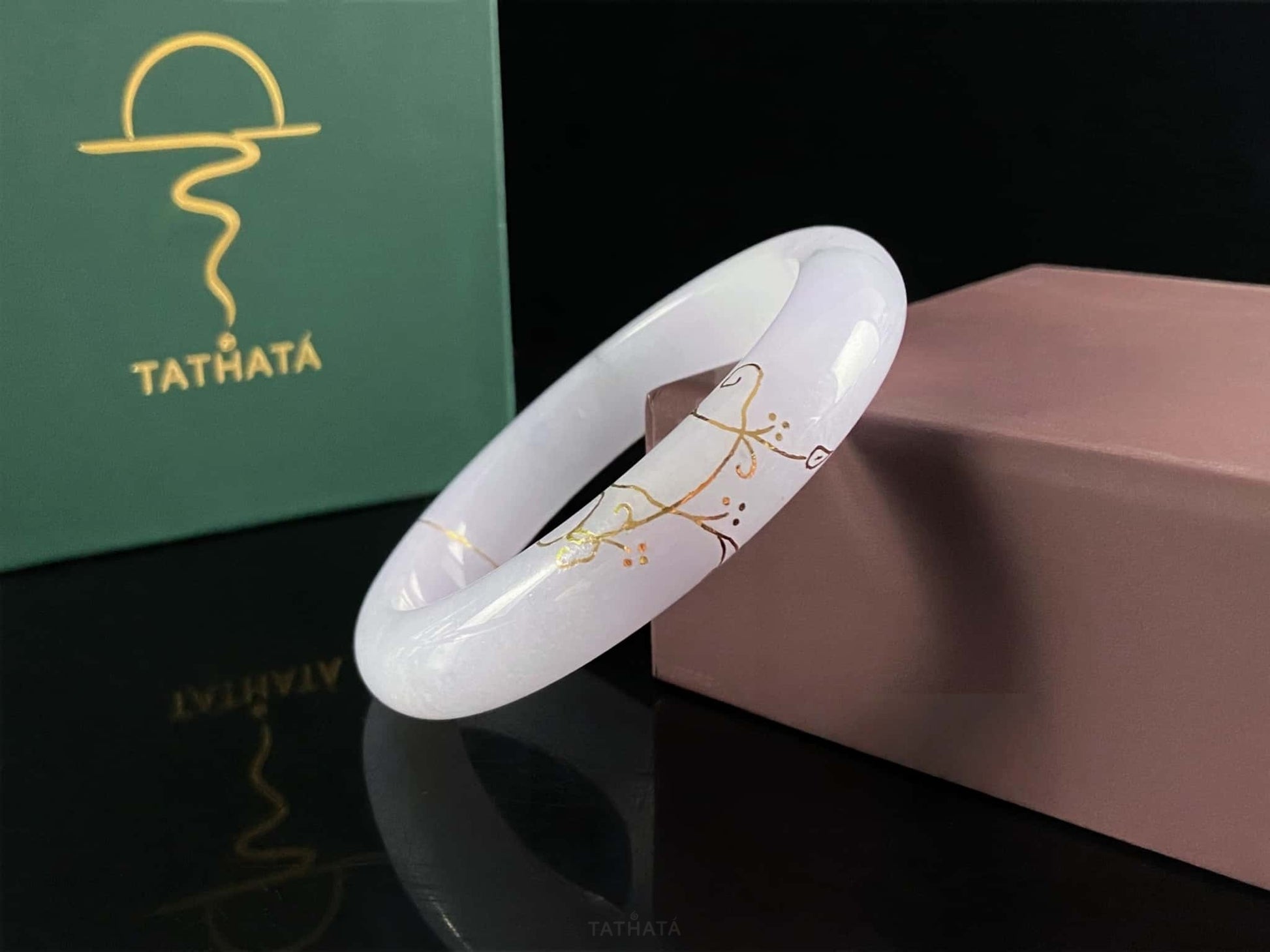 A pale violet golden stitch jadeite bangle.