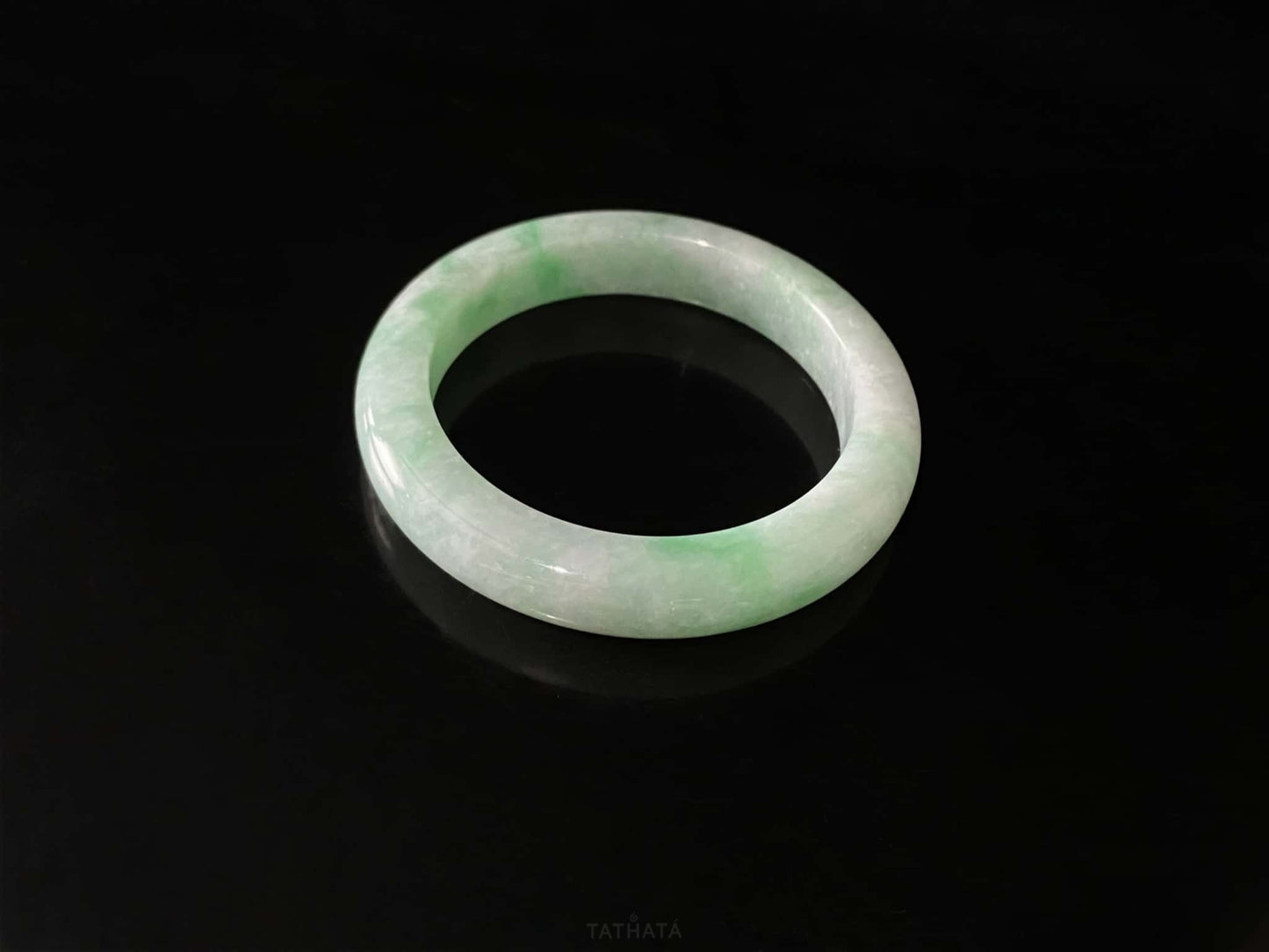 A moss green cloud  jadeite bangle.