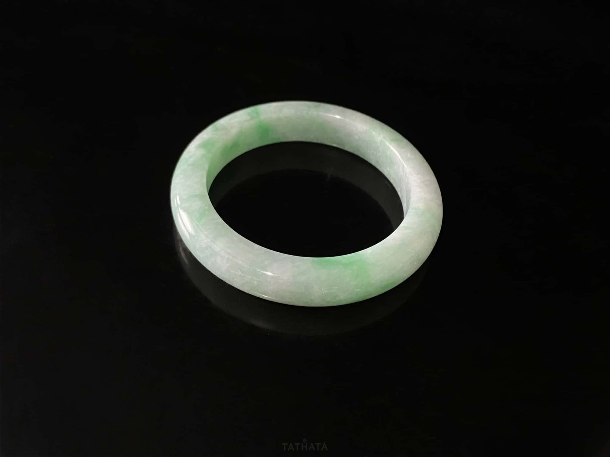 A moss green cloud  jadeite bangle.