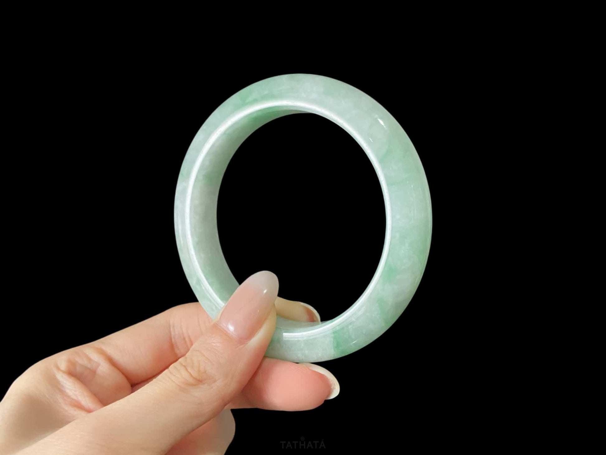 A moss green cloud  jadeite bangle.