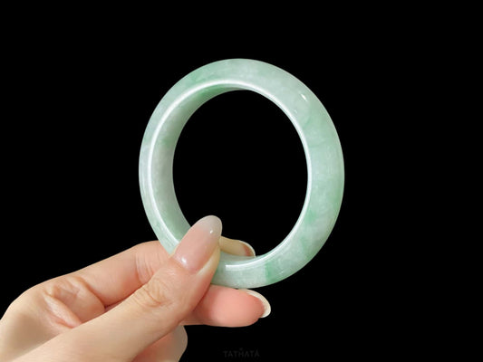 A moss green cloud  jadeite bangle.