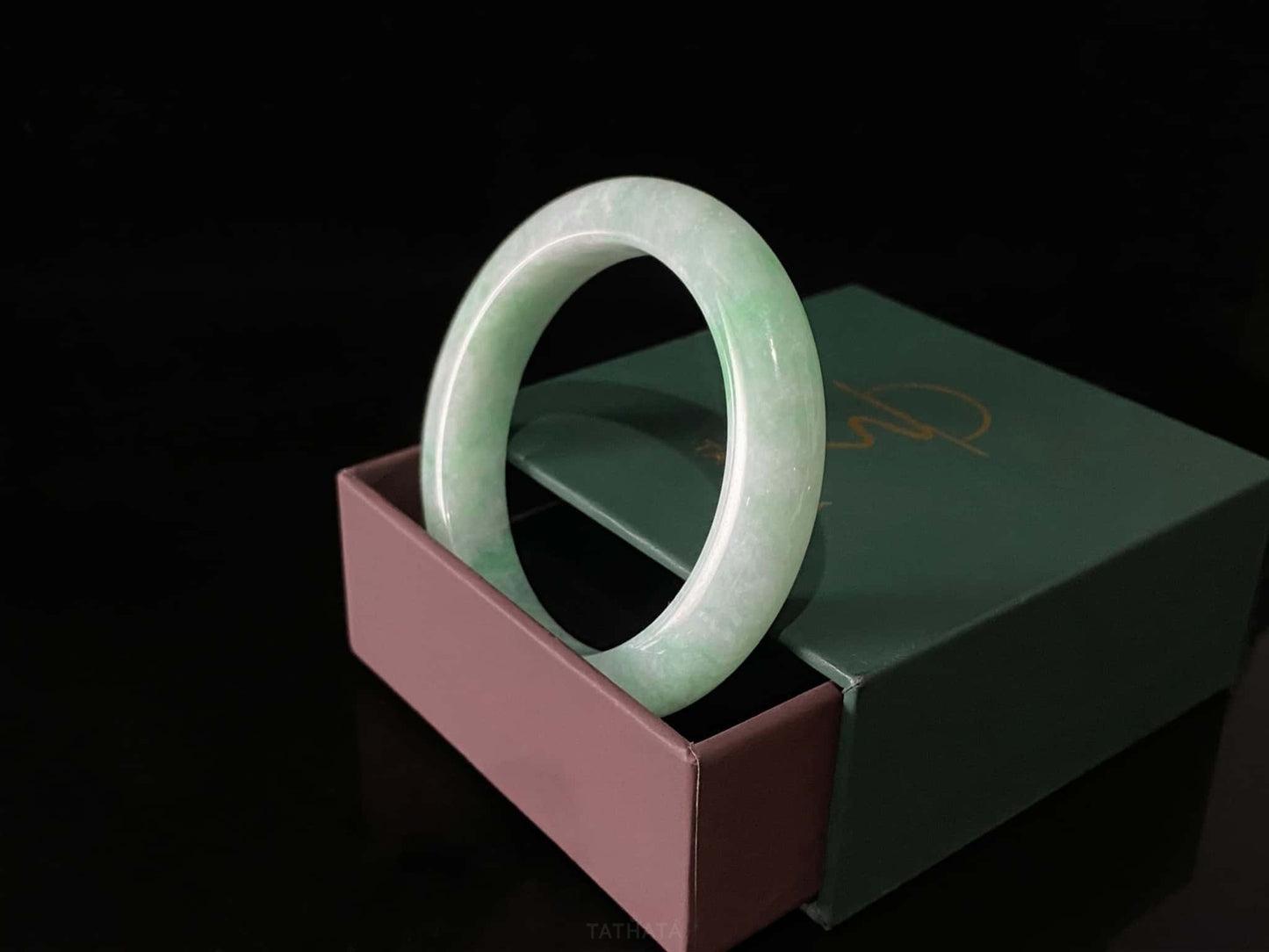 A moss green cloud  jadeite bangle.