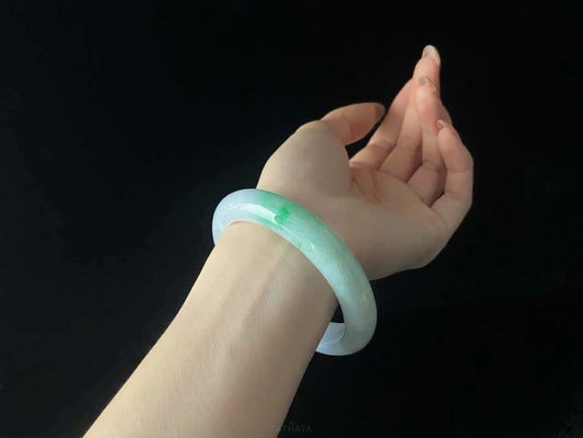 A lavender mint vein jadeite bangle.