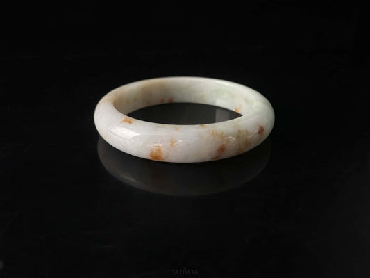 A ivory caramel fleck jadeite bangle.