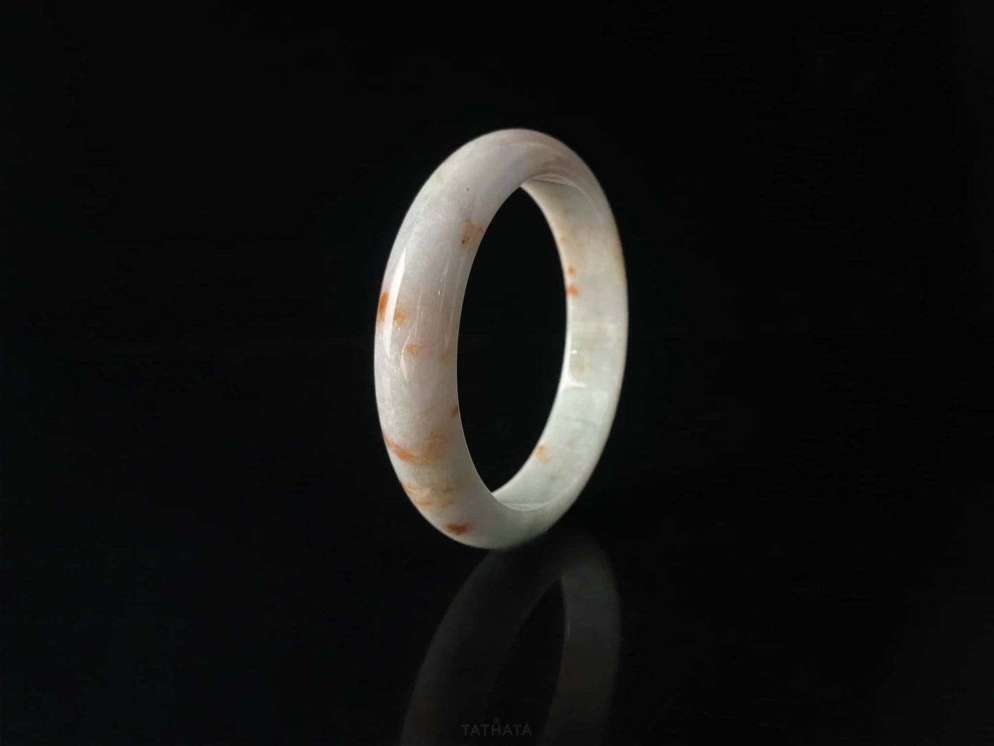A ivory caramel fleck jadeite bangle.