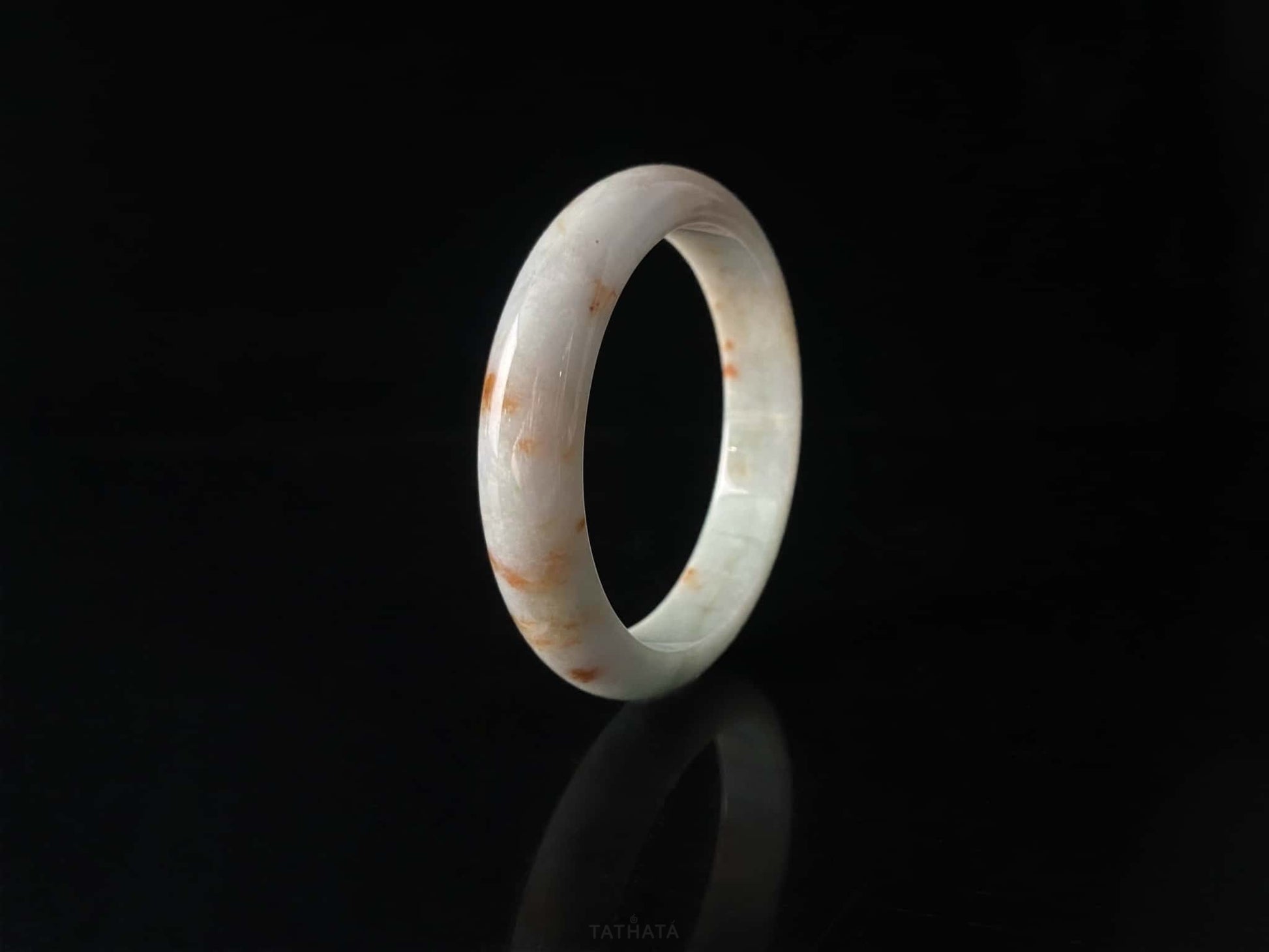 A ivory caramel fleck jadeite bangle.