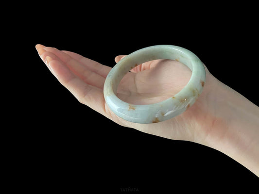 A ivory caramel fleck jadeite bangle.