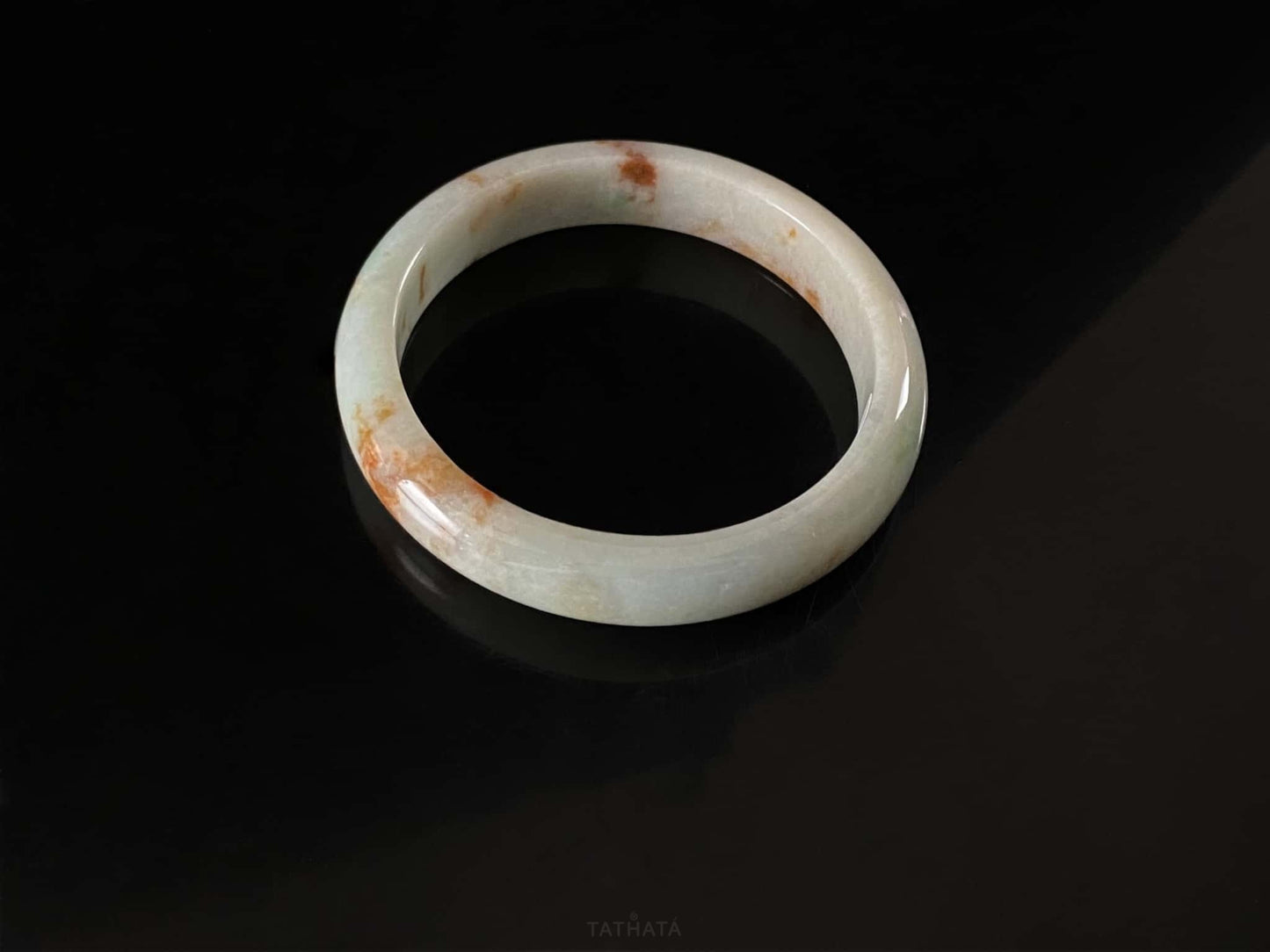A moss coral calm jadeite bangle.