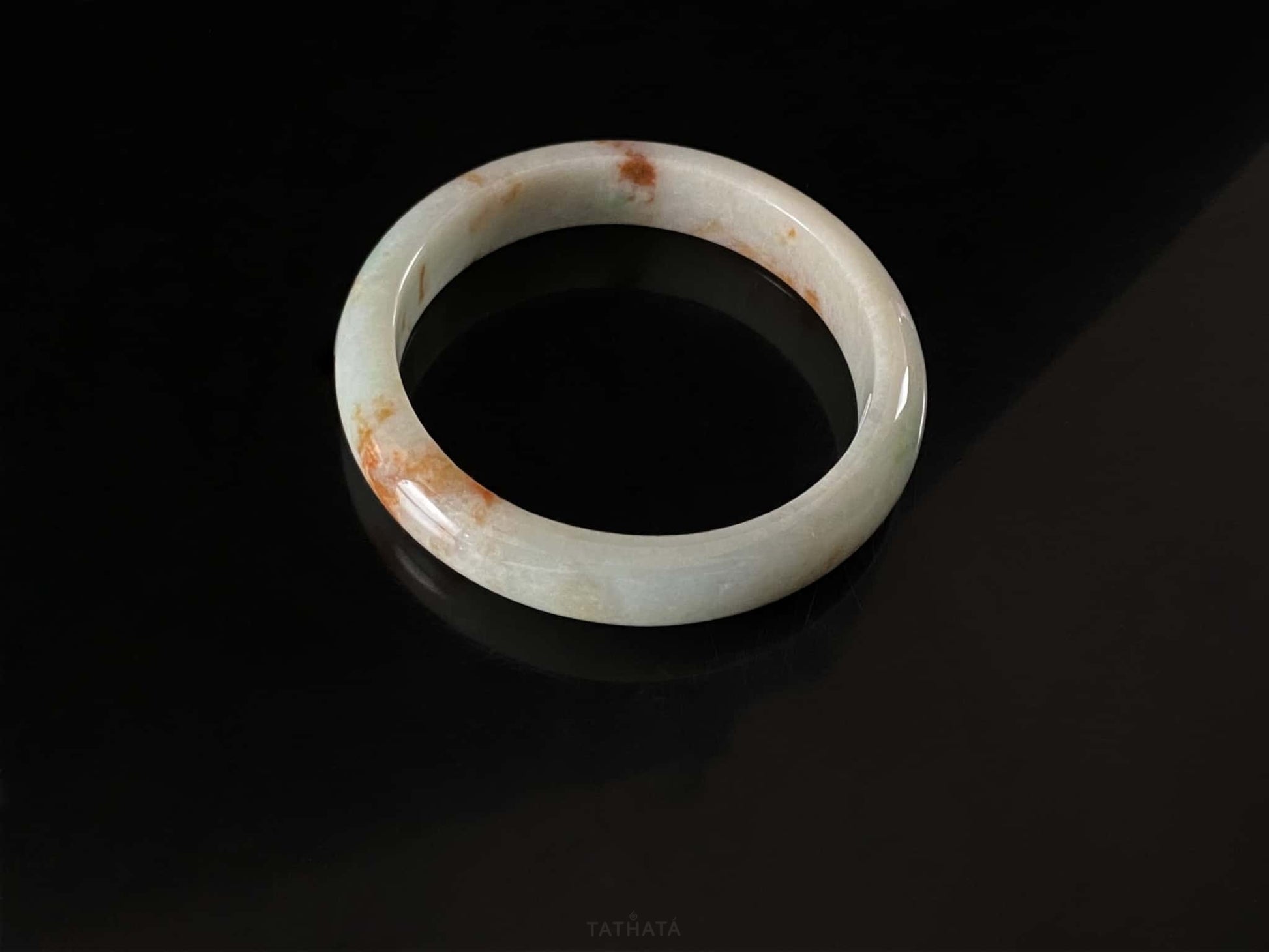 A moss coral calm jadeite bangle.