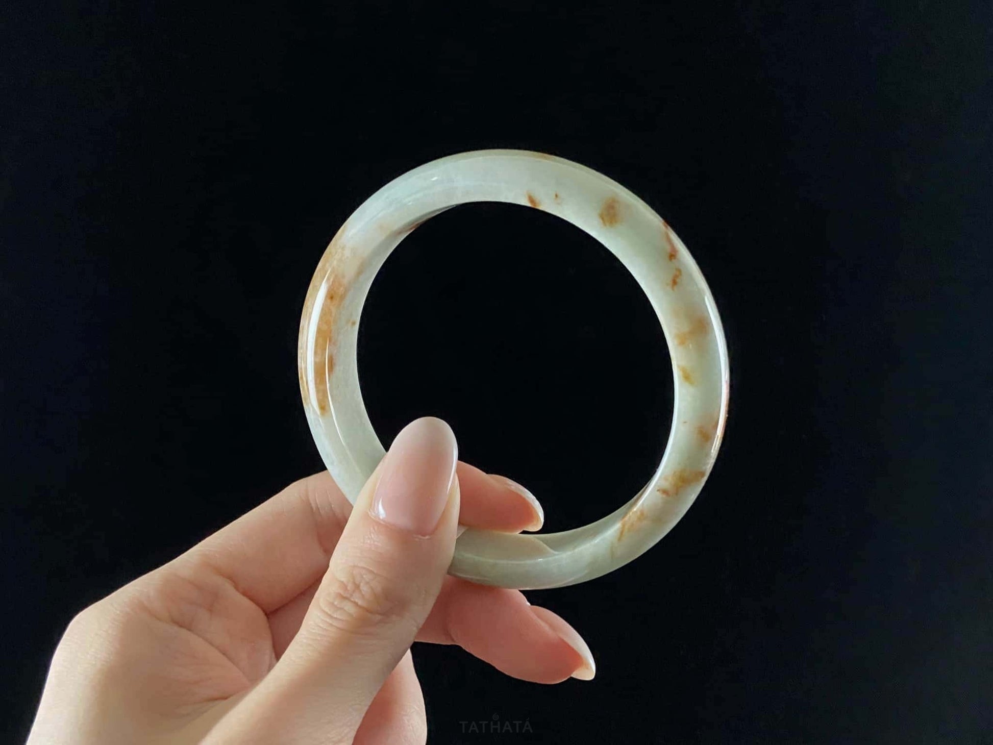 A moss coral calm jadeite bangle.