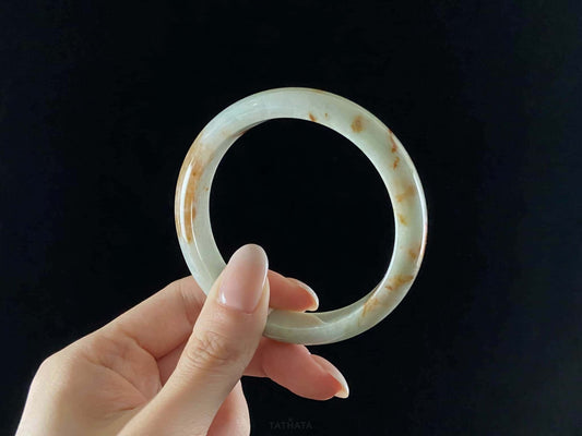 A moss coral calm jadeite bangle.