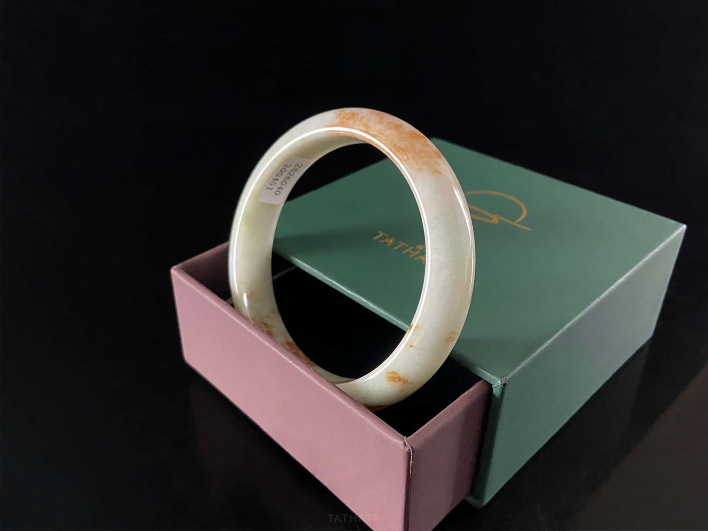 A moss coral calm jadeite bangle.