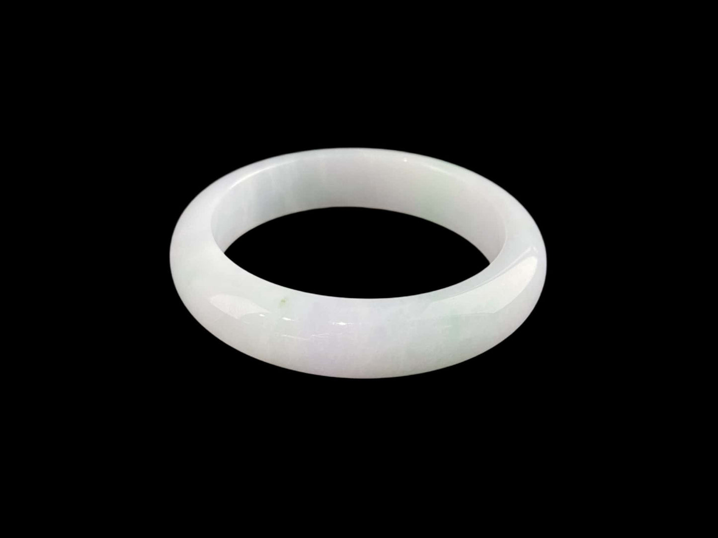 A pristine white with green veil jadeite bangle.