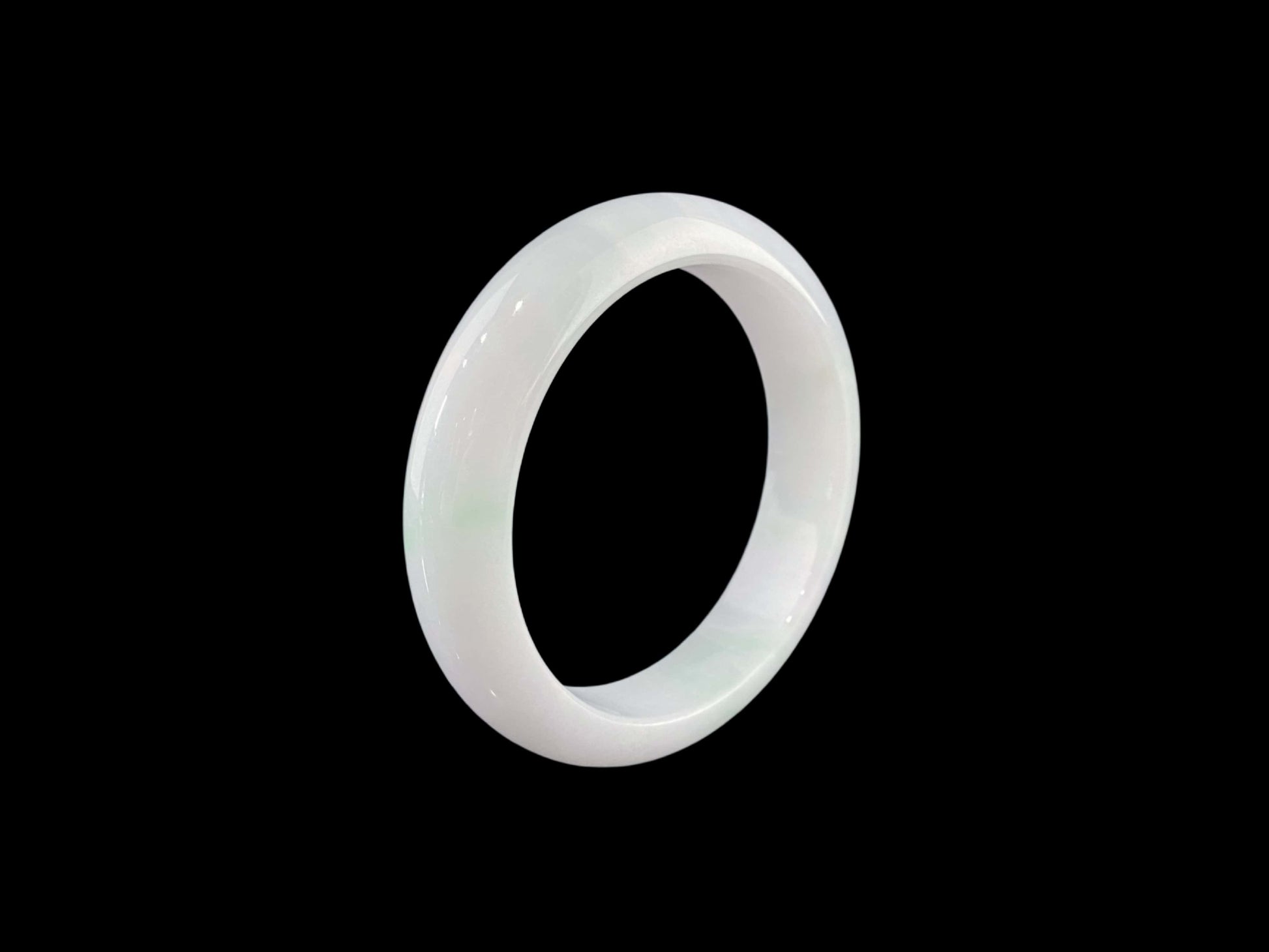 A pristine white with green veil jadeite bangle.