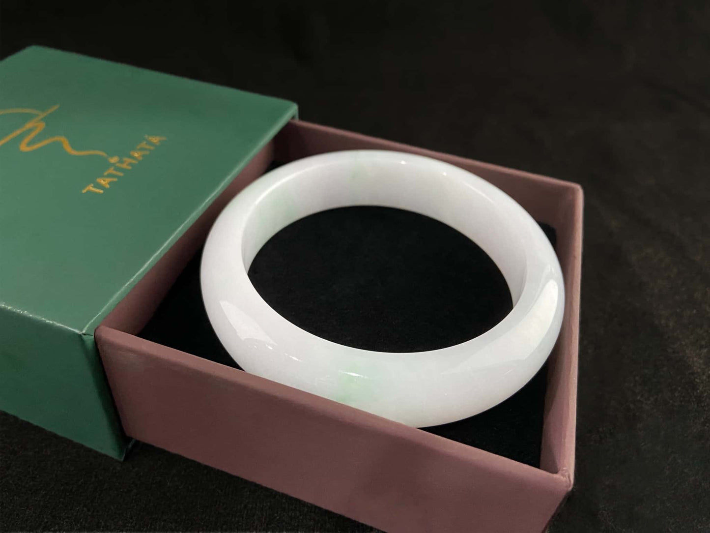 A pristine white with green veil jadeite bangle.