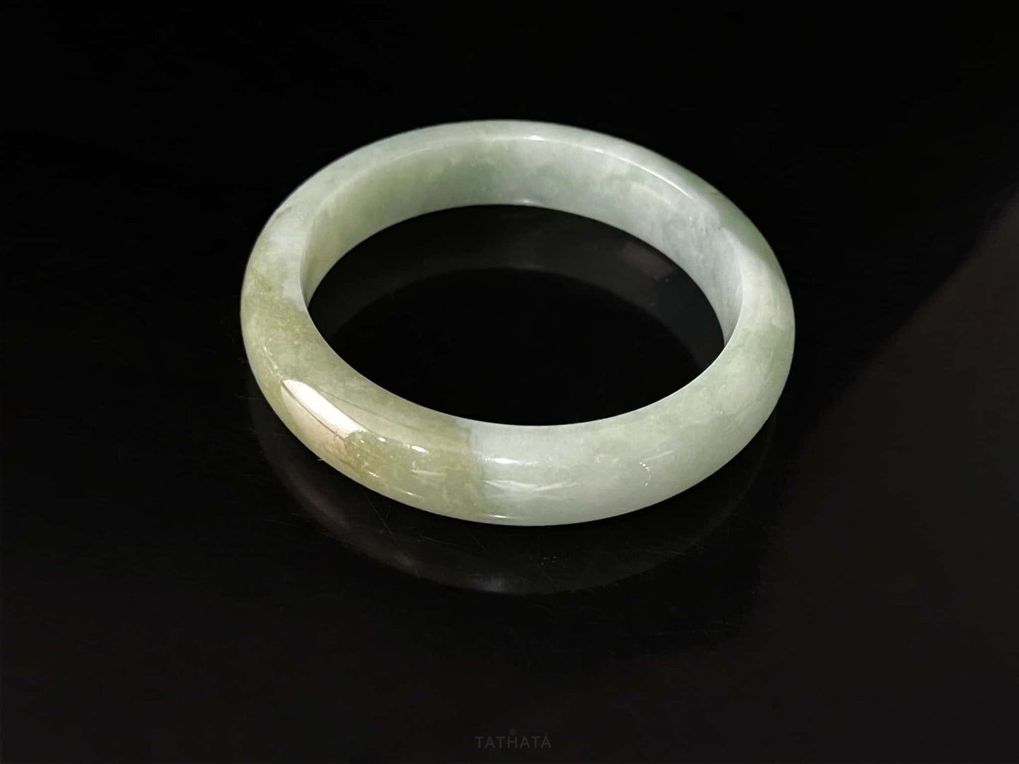 A frosted fern hue jadeite bangle.