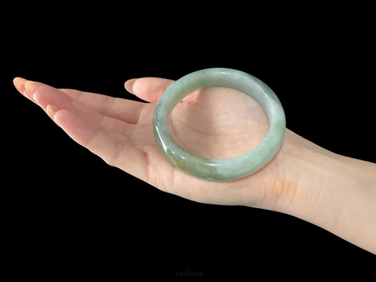 A frosted fern hue jadeite bangle.