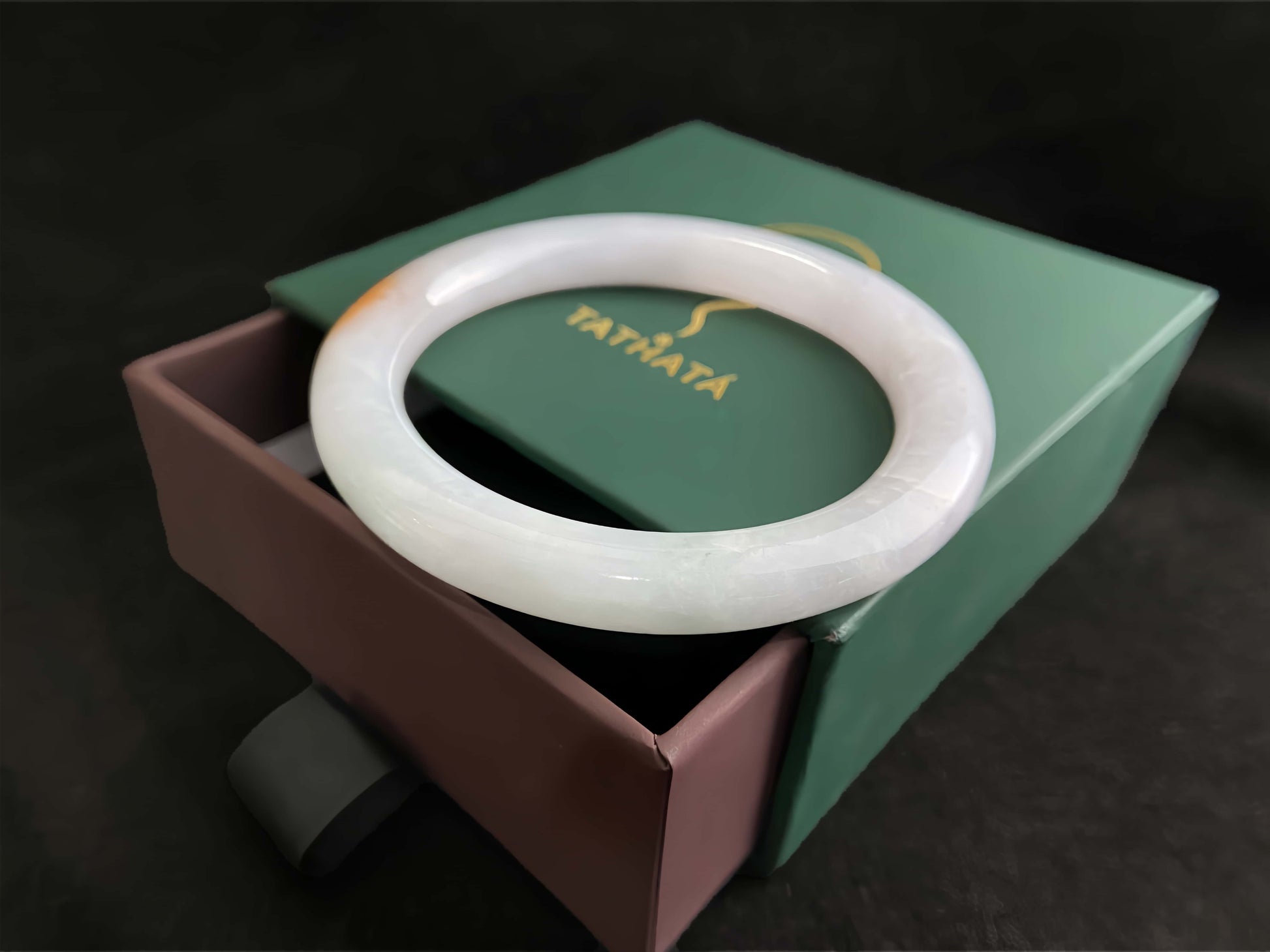 A pure white warm orange inlay jadeite bangle.