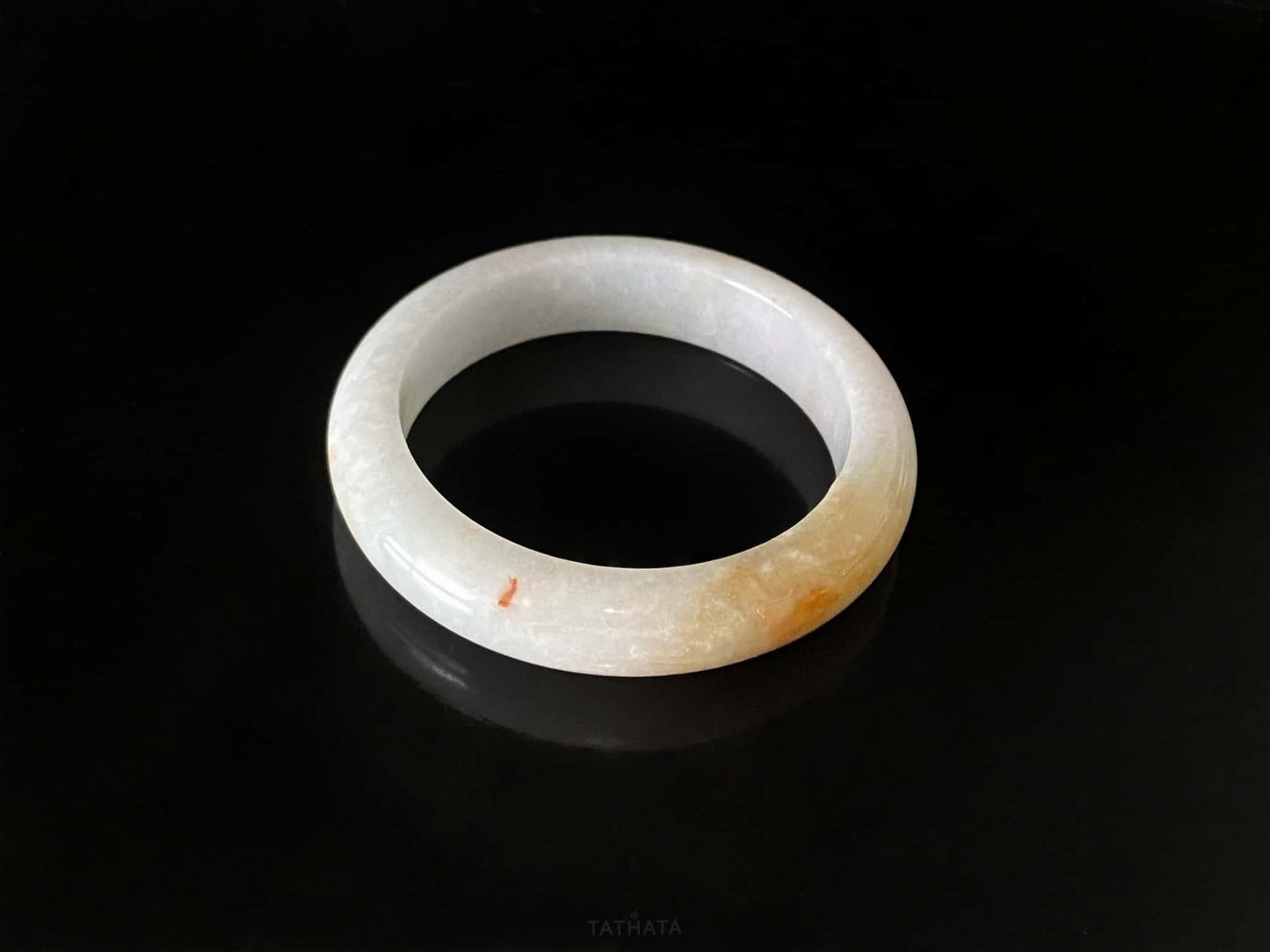A creamy sunlit veil jadeite bangle.