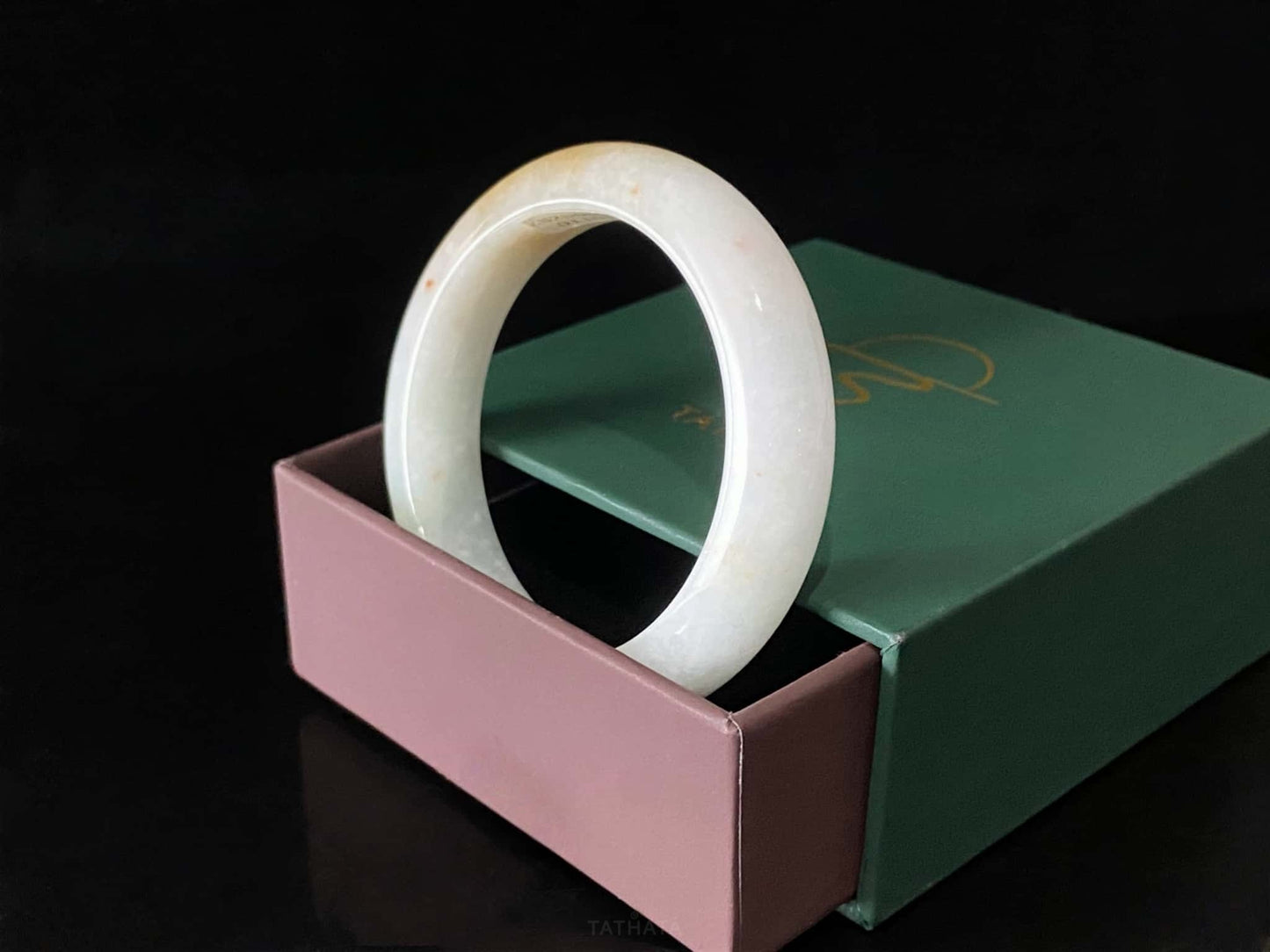 A creamy sunlit veil jadeite bangle.