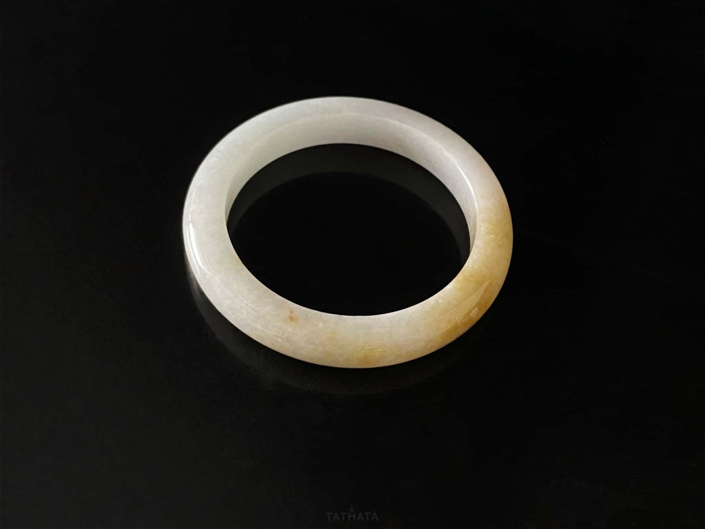 A golden honey veil jadeite bangle.