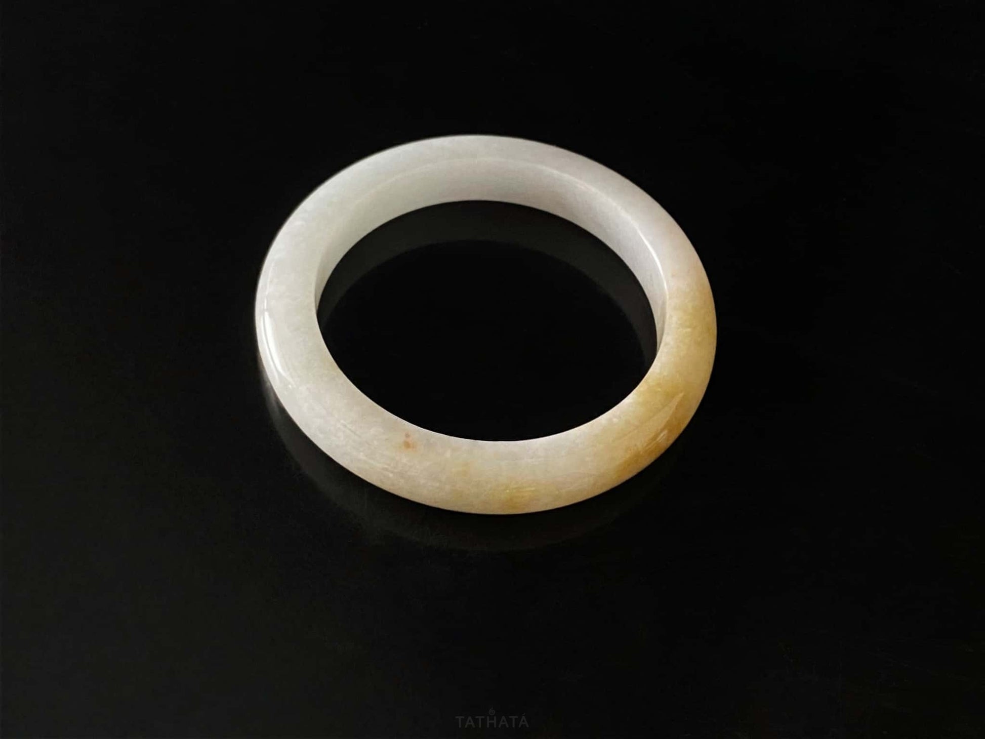 A golden honey veil jadeite bangle.