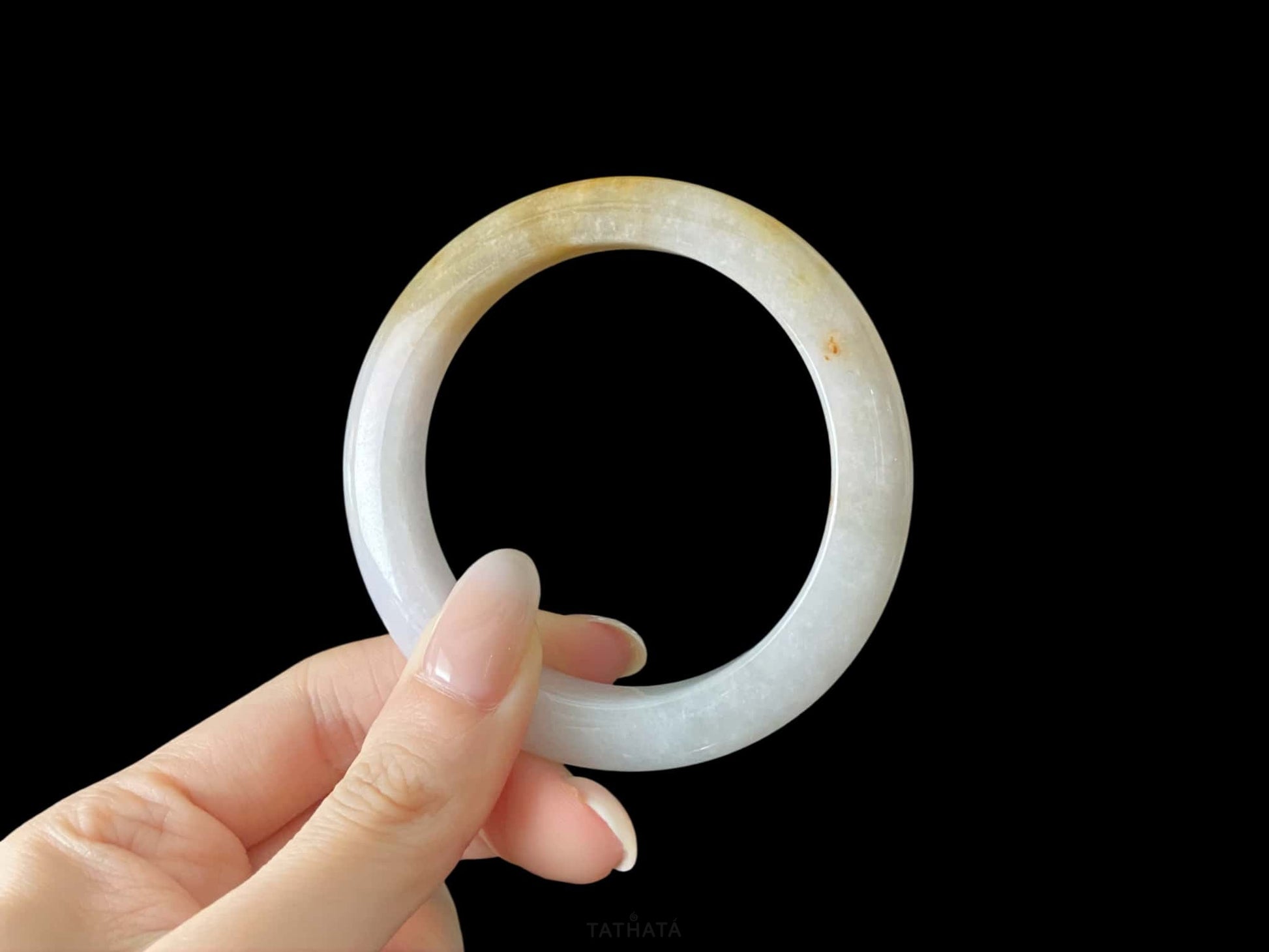 A golden honey veil jadeite bangle.