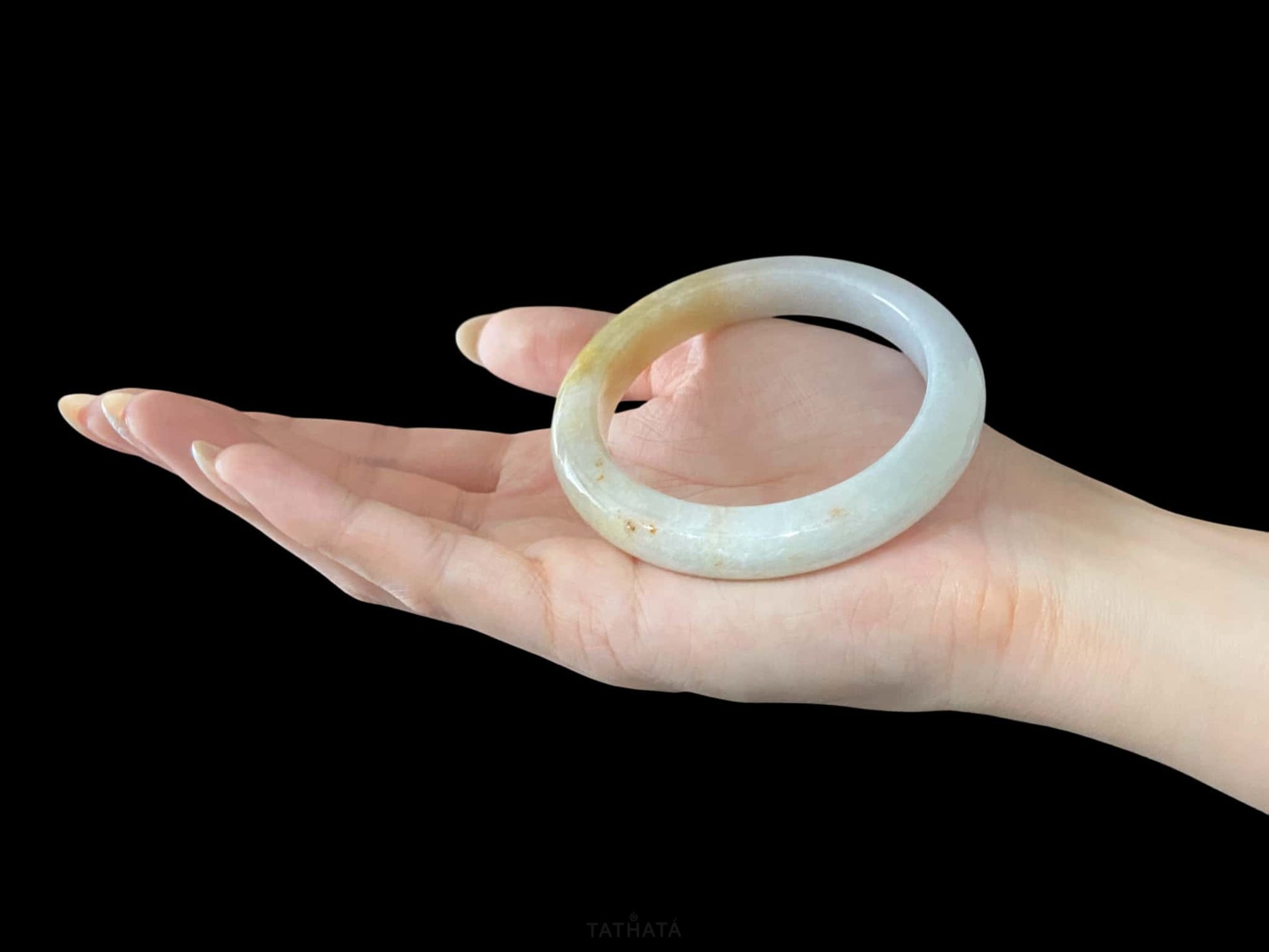 A golden honey veil jadeite bangle.