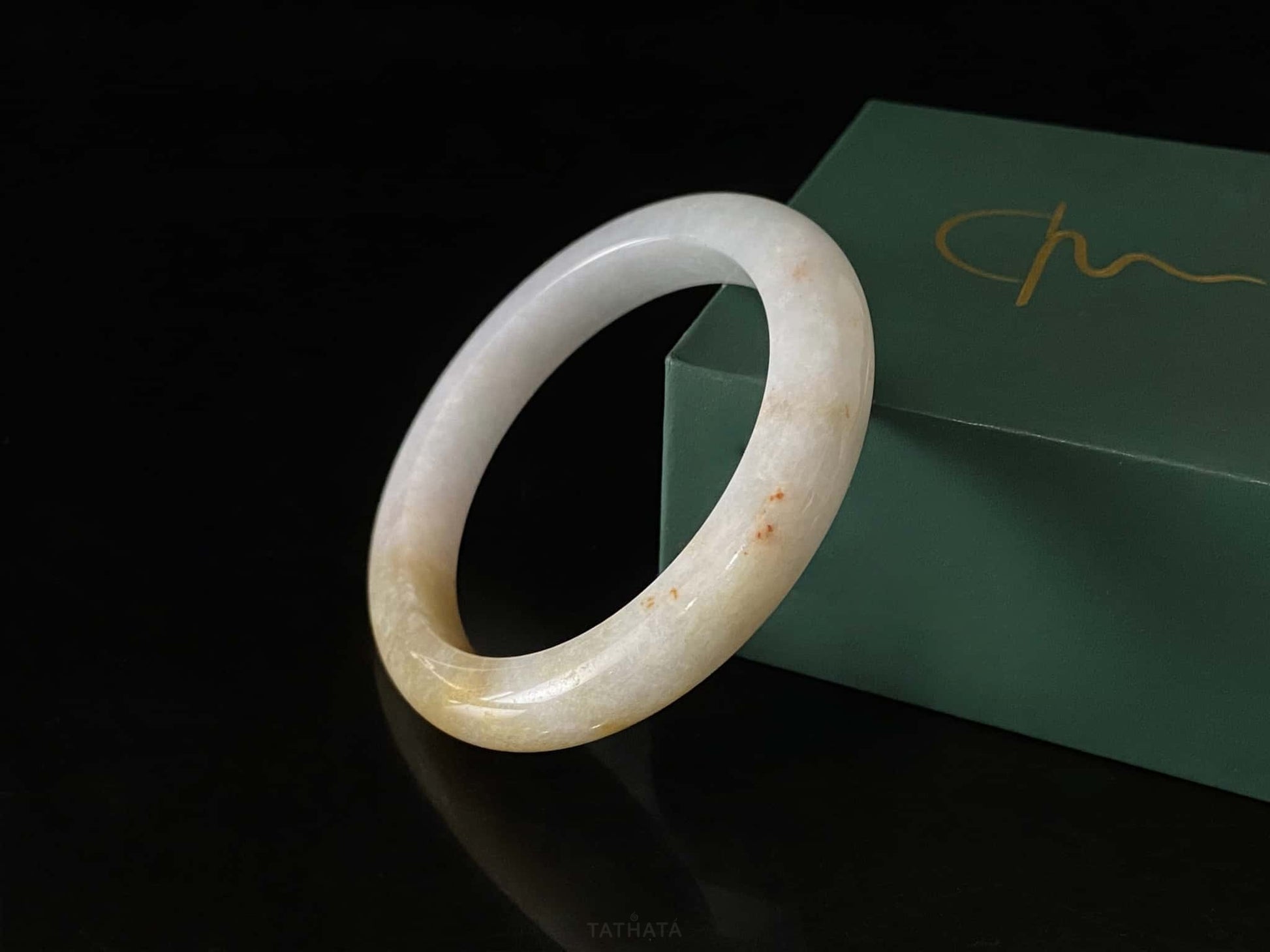 A golden honey veil jadeite bangle.