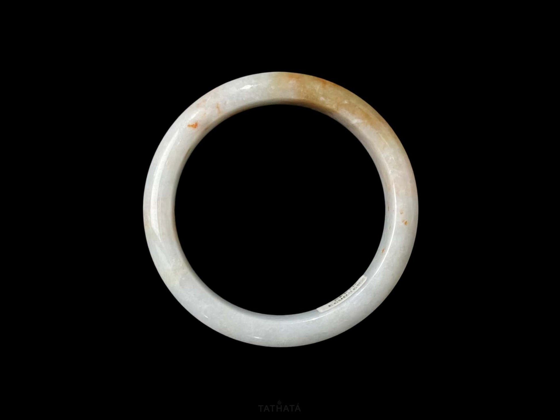 A amber dawn vein jadeite bangle.