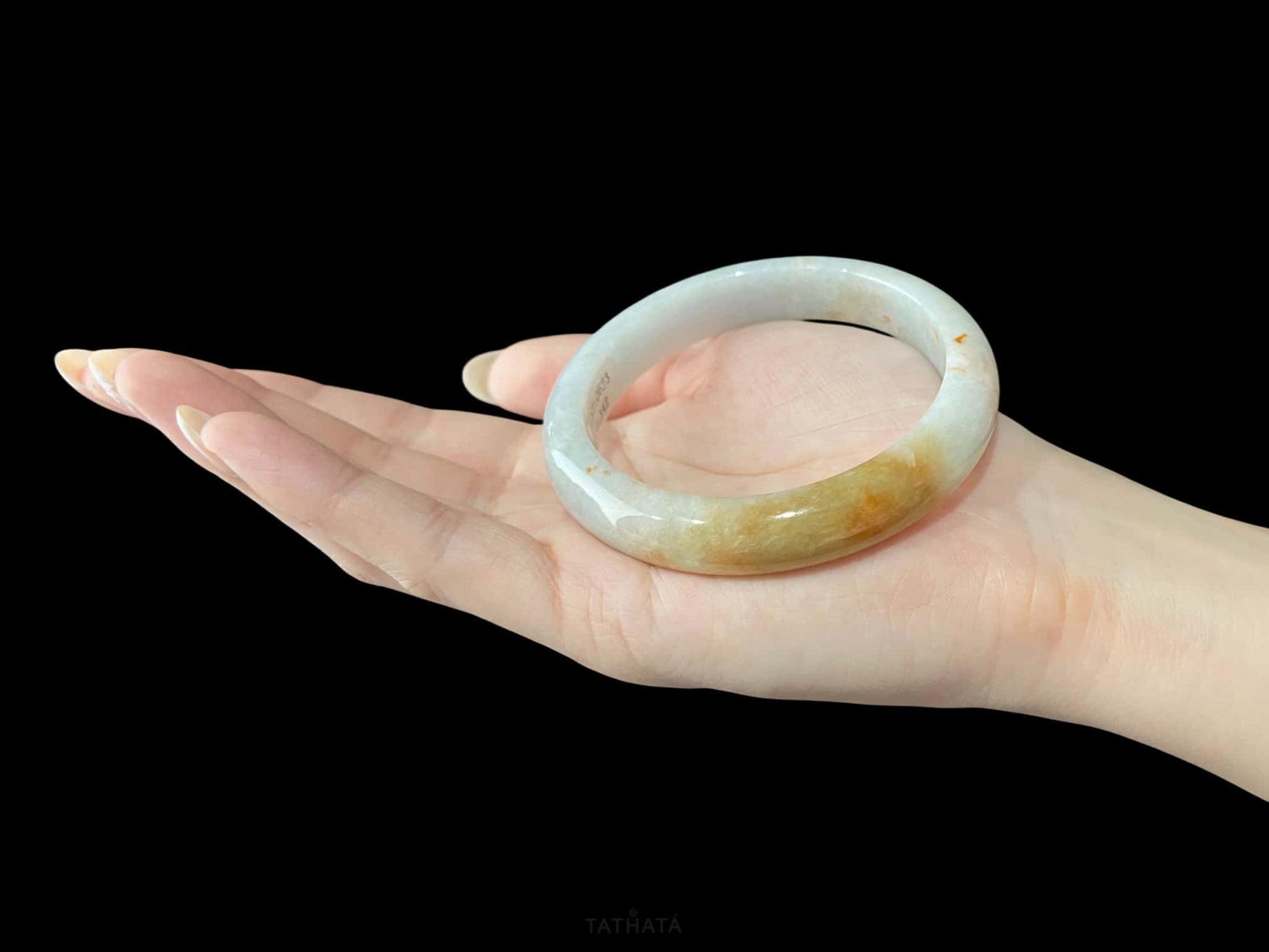 A amber dawn vein jadeite bangle.