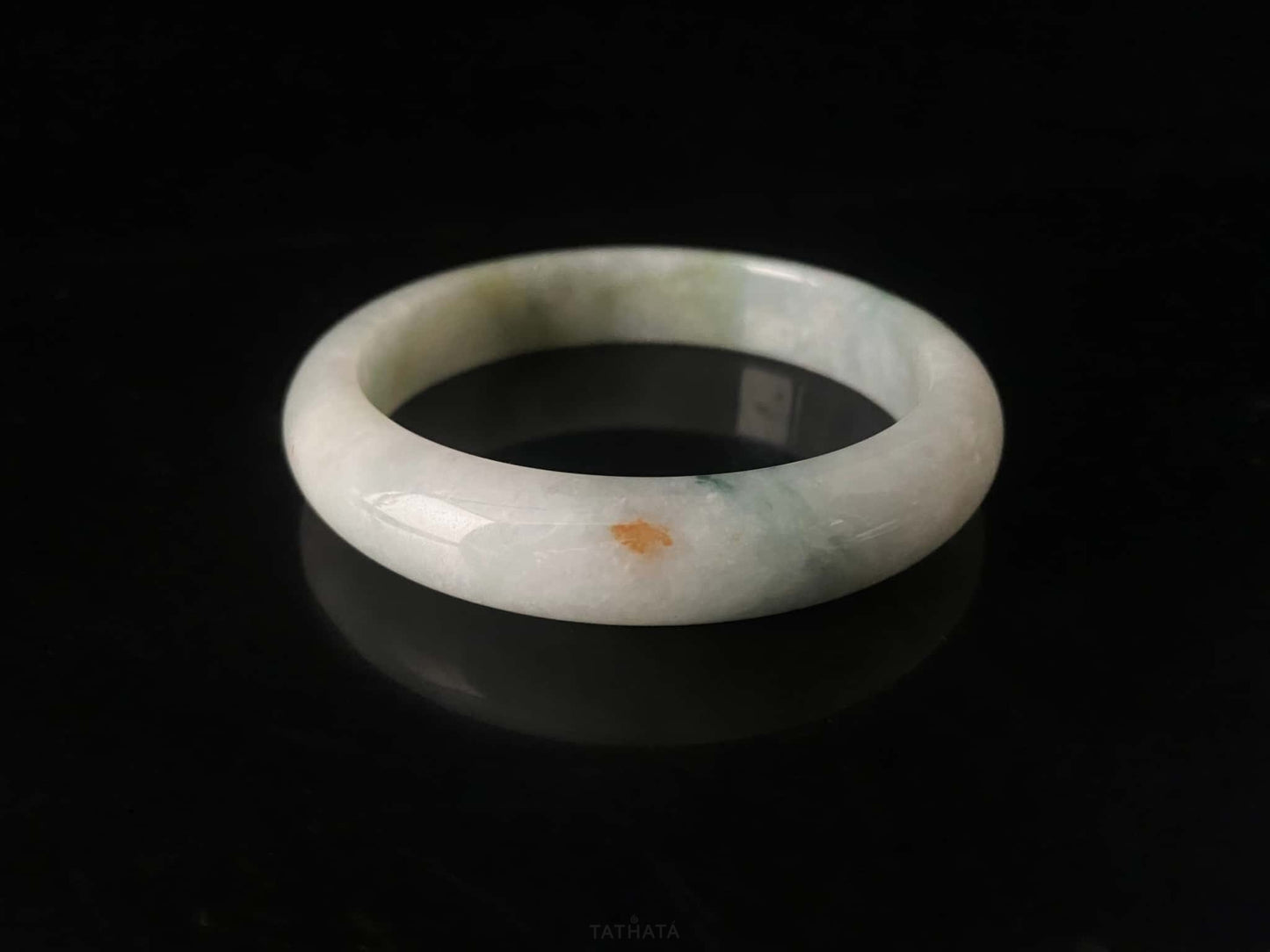 A milky mint honey spot jadeite bangle.