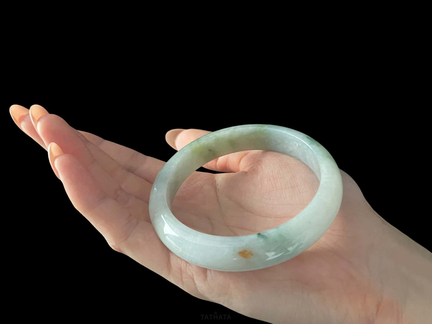 A milky mint honey spot jadeite bangle.