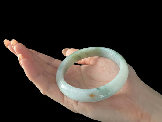 A milky mint honey spot jadeite bangle.